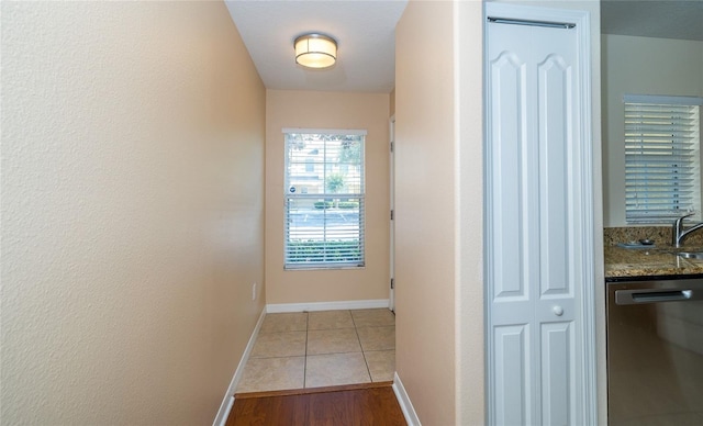 37712 Aaralyn Rd, Zephyrhills, FL 33542 - corridor with light tile patterned floors and baseboards