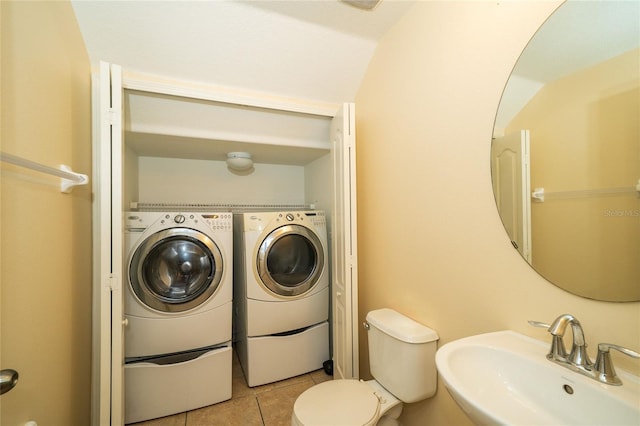 37712 Aaralyn Rd, Zephyrhills, FL 33542 - bathroom featuring a sink, washer and dryer, tile patterned flooring, and toilet
