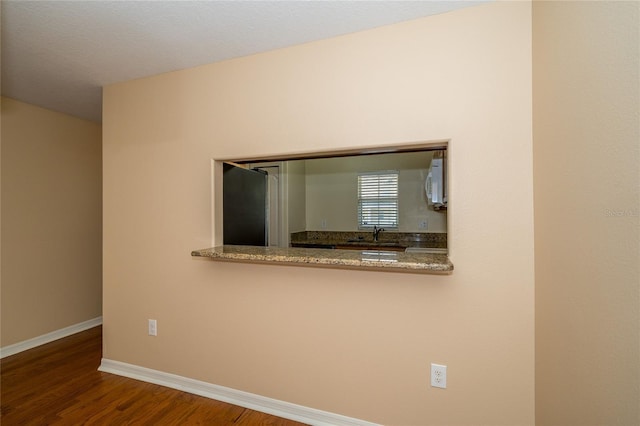 37712 Aaralyn Rd, Zephyrhills, FL 33542 - unfurnished room with wood finished floors, baseboards, and a sink