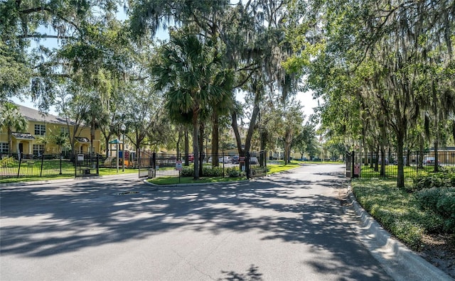 37712 Aaralyn Rd, Zephyrhills, FL 33542 - view of asphalt street featuring curbs and a gated entry