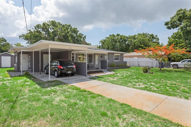 4512 S Lois Ave, Tampa, FL 33611 - single story home featuring an attached carport, concrete driveway, and brick siding