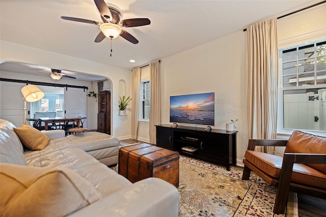 2519 1st Ave N, Saint Petersburg, FL 33713 - living room with ceiling fan, arched walkways, and baseboards