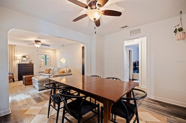 2519 1st Ave N, Saint Petersburg, FL 33713 - dining area with arched walkways, ceiling fan, and light wood-type flooring