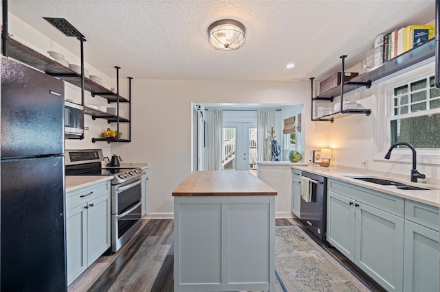 2519 1st Ave N, Saint Petersburg, FL 33713 - kitchen featuring open shelves, black appliances, butcher block countertops, a sink, and a textured ceiling