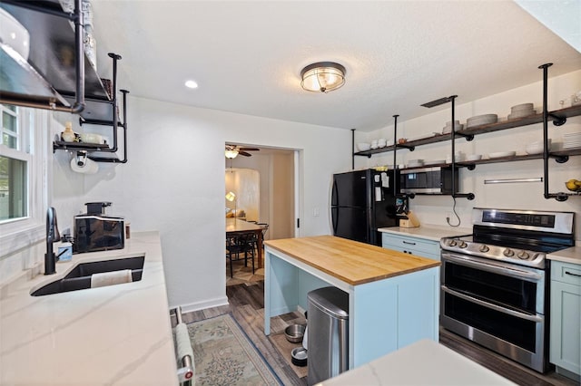 2519 1st Ave N, Saint Petersburg, FL 33713 - kitchen with stainless steel appliances, open shelves, wooden counters, a sink, and dark wood-style flooring