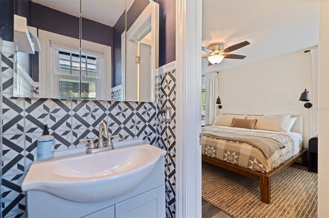 2519 1st Ave N, Saint Petersburg, FL 33713 - ensuite bathroom featuring vanity, a ceiling fan, healthy amount of natural light, and wood finished floors