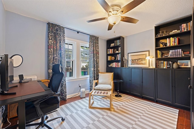 2519 1st Ave N, Saint Petersburg, FL 33713 - office area featuring a ceiling fan, light wood-style floors, a textured ceiling, built in shelves, and baseboards