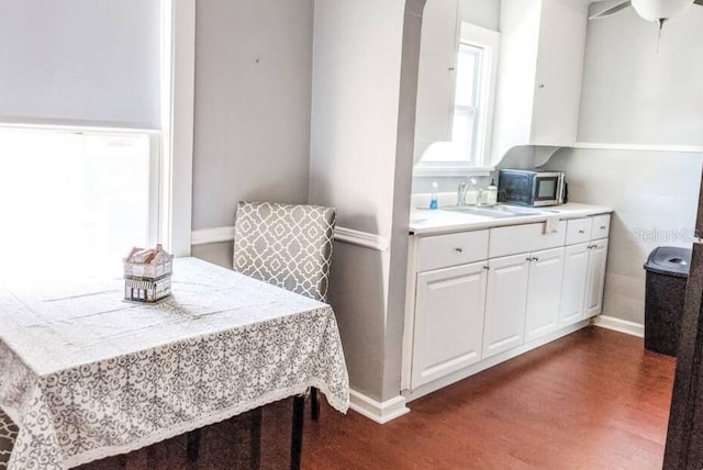 2519 1st Ave N, Saint Petersburg, FL 33713 - dining area featuring baseboards and dark wood-style flooring