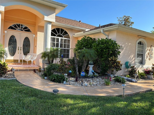 13339 Amberwood St, Hudson, FL 34669 - property entrance featuring french doors and stucco siding