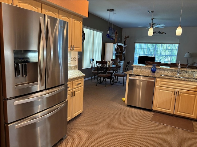 13339 Amberwood St, Hudson, FL 34669 - kitchen with stainless steel appliances, a sink, ceiling fan, carpet floors, and pendant lighting
