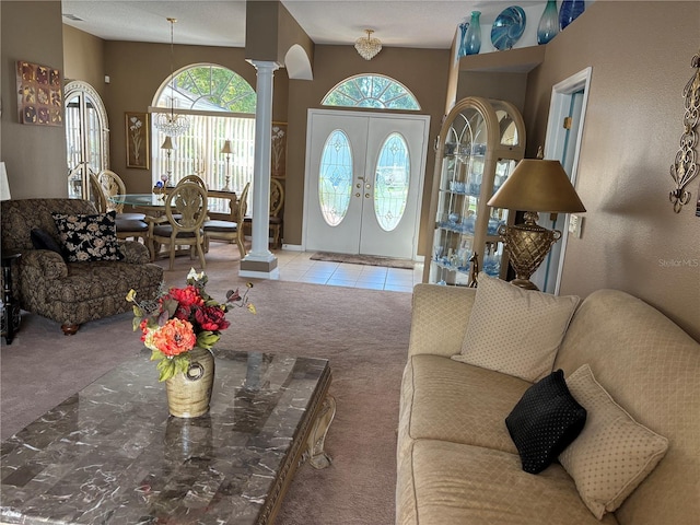 13339 Amberwood St, Hudson, FL 34669 - carpeted living area featuring decorative columns, french doors, and tile patterned flooring