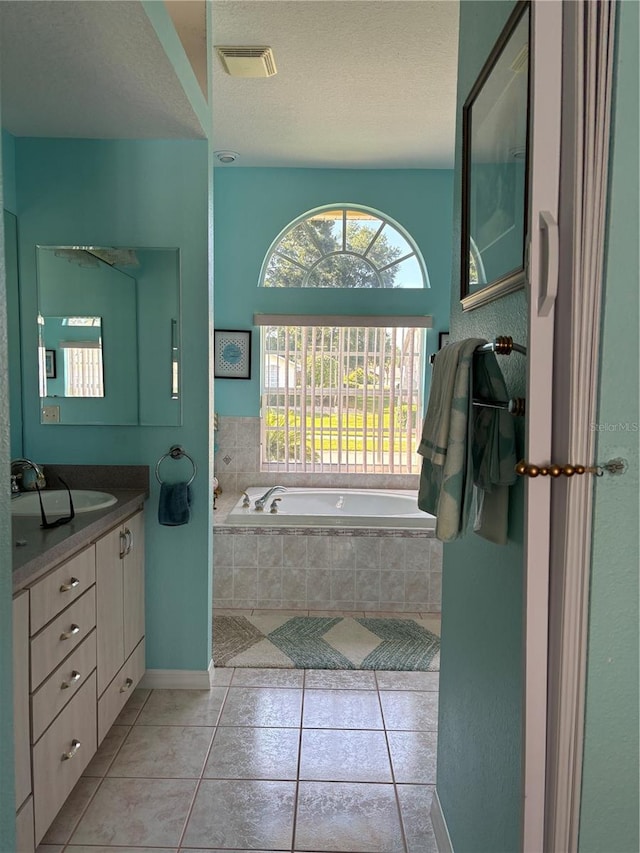 13339 Amberwood St, Hudson, FL 34669 - full bath featuring a garden tub, vanity, tile patterned floors, and a textured ceiling