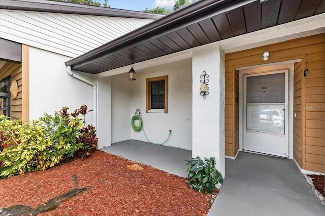 7633 Piping Rock Ct Unit 7633, New Port Richey, FL 34654 - doorway to property featuring stucco siding and covered porch