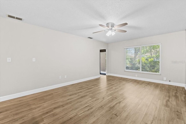 7633 Piping Rock Ct Unit 7633, New Port Richey, FL 34654 - spare room featuring a ceiling fan, a textured ceiling, wood finished floors, and baseboards