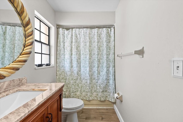 7633 Piping Rock Ct Unit 7633, New Port Richey, FL 34654 - bathroom featuring vanity, toilet, wood finished floors, and baseboards