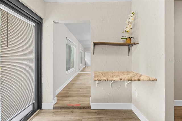 7633 Piping Rock Ct Unit 7633, New Port Richey, FL 34654 - corridor featuring wood finished floors and baseboards