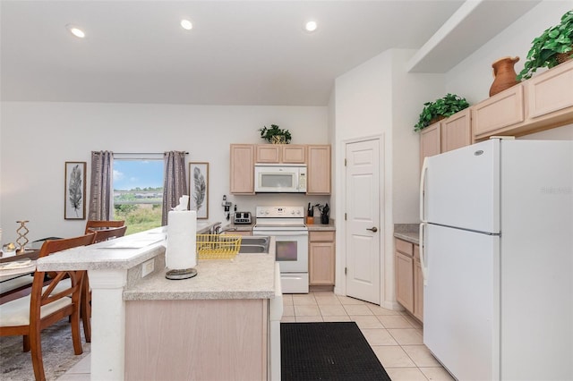 908 Andalusia Loop, Davenport, FL 33837 - kitchen with white appliances, light brown cabinetry, a sink, light countertops, and light tile patterned flooring