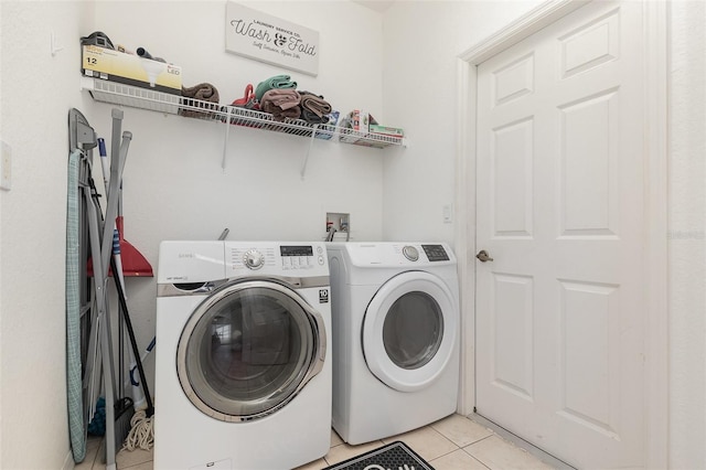 908 Andalusia Loop, Davenport, FL 33837 - laundry room with light tile patterned floors and washer and clothes dryer