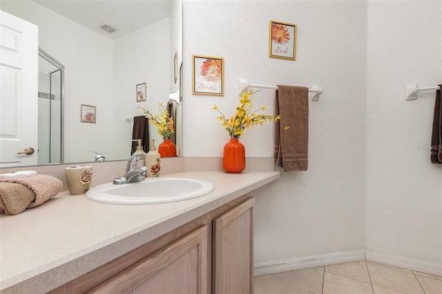 908 Andalusia Loop, Davenport, FL 33837 - bathroom with vanity, tile patterned floors, and baseboards