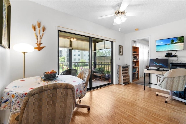 8174 Terrace Garden Dr N Unit 204, Saint Petersburg, FL 33709 - dining area featuring wood finished floors, a ceiling fan, and a textured ceiling