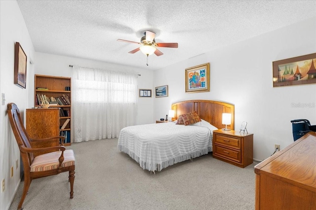 8174 Terrace Garden Dr N Unit 204, Saint Petersburg, FL 33709 - bedroom featuring carpet flooring, a textured ceiling, and a ceiling fan