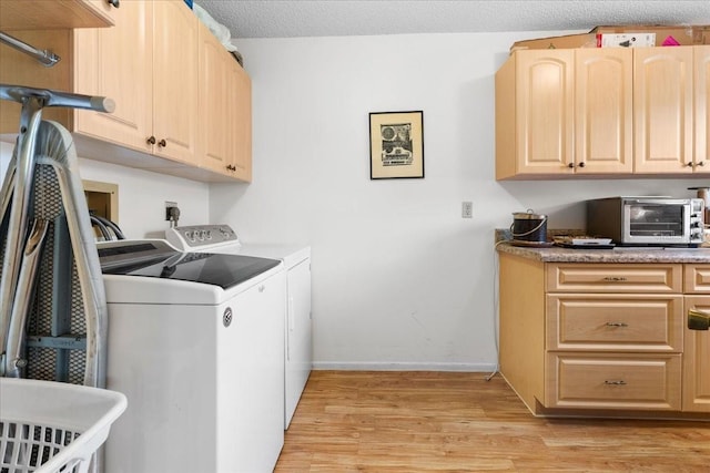 8174 Terrace Garden Dr N Unit 204, Saint Petersburg, FL 33709 - laundry room with washing machine and dryer, light wood finished floors, baseboards, and cabinet space