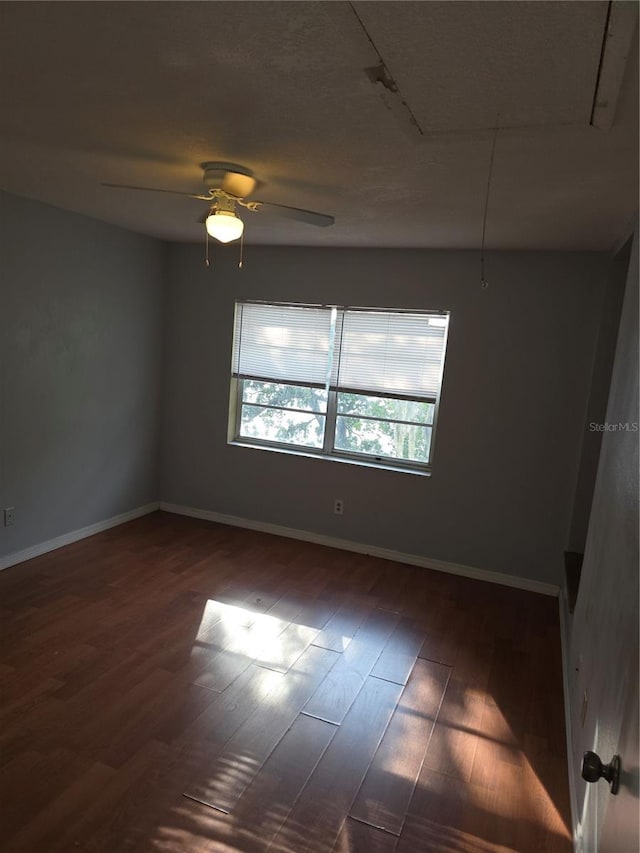 7168 E Bank Dr Unit 7168, Tampa, FL 33617 - empty room with attic access, wood finished floors, baseboards, and a ceiling fan