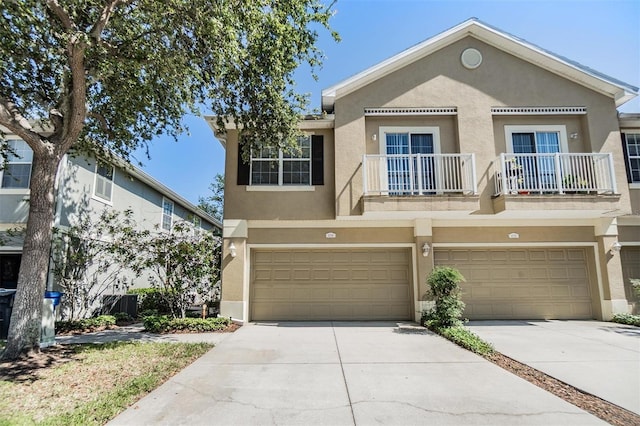 6736 Breezy Palm Dr, Riverview, FL 33578 - view of property featuring stucco siding, a garage, concrete driveway, and a balcony