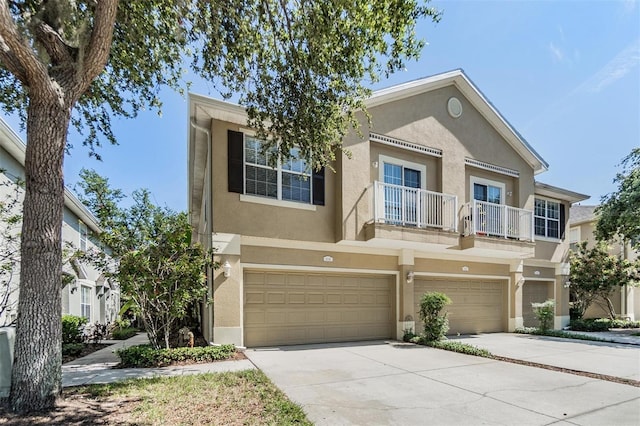 6736 Breezy Palm Dr, Riverview, FL 33578 - view of property with stucco siding, an attached garage, a balcony, and driveway