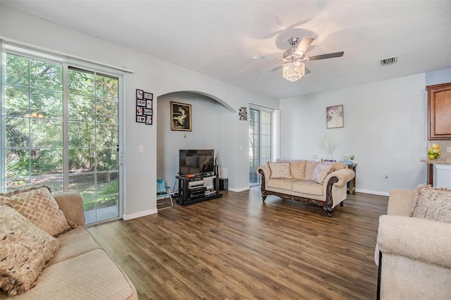 6736 Breezy Palm Dr, Riverview, FL 33578 - living room with healthy amount of natural light, arched walkways, wood finished floors, and a ceiling fan