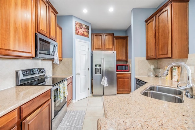 6736 Breezy Palm Dr, Riverview, FL 33578 - kitchen featuring stainless steel appliances, a sink, light stone countertops, brown cabinets, and recessed lighting