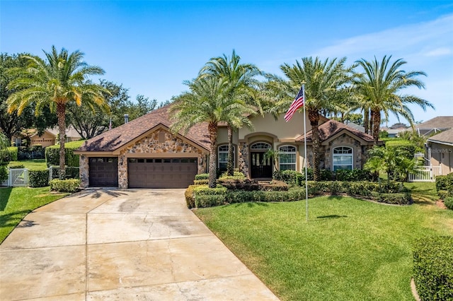 2041 Gold Dust Ct, Trinity, FL 34655 - mediterranean / spanish-style home with a front lawn, stone siding, an attached garage, concrete driveway, and stucco siding