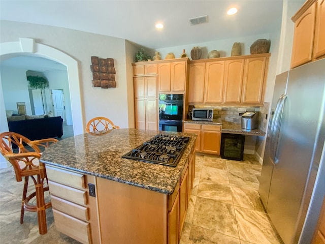 2041 Gold Dust Ct, Trinity, FL 34655 - kitchen featuring black appliances, arched walkways, light brown cabinets, dark stone countertops, and recessed lighting