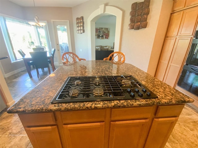 2041 Gold Dust Ct, Trinity, FL 34655 - kitchen featuring black appliances, arched walkways, dark stone countertops, pendant lighting, and a chandelier