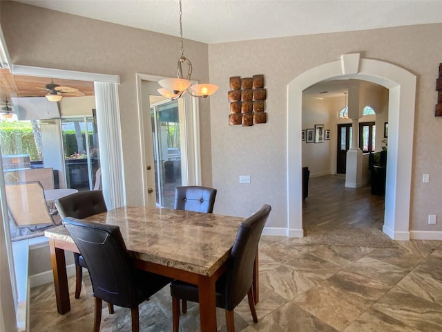 2041 Gold Dust Ct, Trinity, FL 34655 - dining room featuring arched walkways, baseboards, and a chandelier