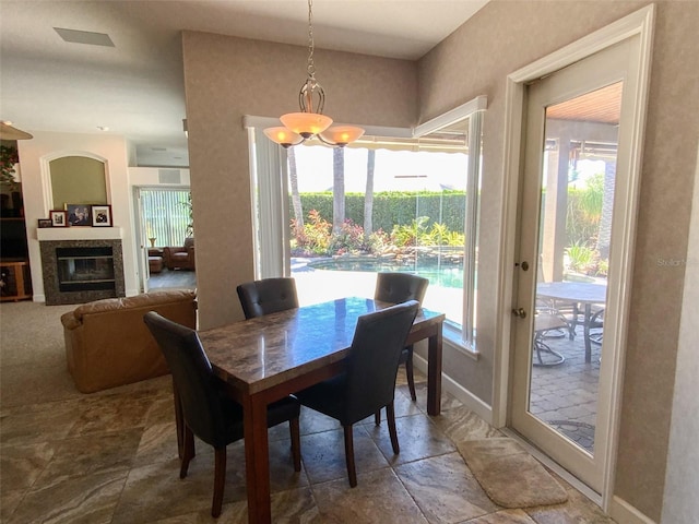 2041 Gold Dust Ct, Trinity, FL 34655 - dining area with baseboards and a tile fireplace