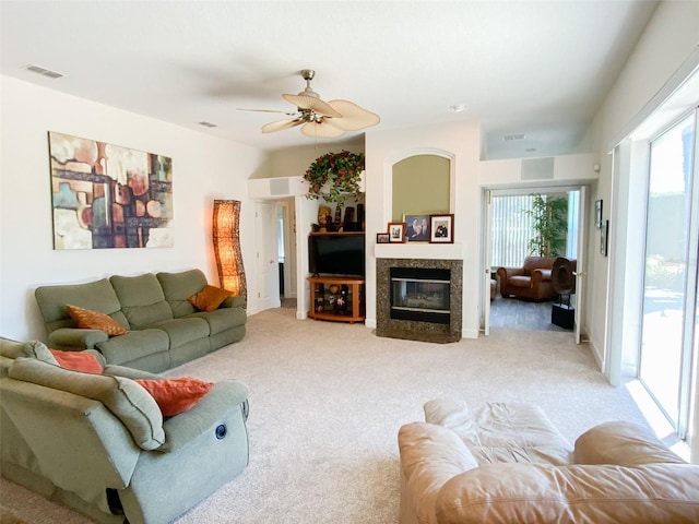 2041 Gold Dust Ct, Trinity, FL 34655 - living room featuring light carpet, a ceiling fan, and a premium fireplace