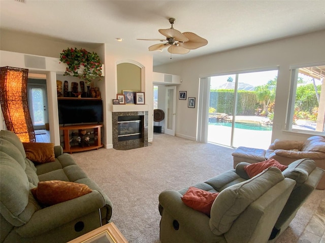2041 Gold Dust Ct, Trinity, FL 34655 - living room featuring a ceiling fan, light colored carpet, a high end fireplace, and baseboards