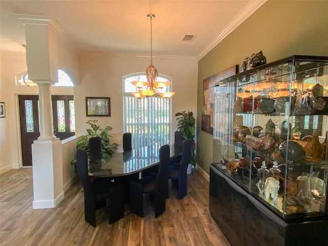 2041 Gold Dust Ct, Trinity, FL 34655 - dining room with decorative columns, wood finished floors, a chandelier, ornamental molding, and baseboards