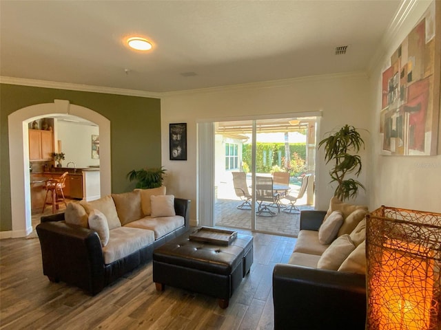 2041 Gold Dust Ct, Trinity, FL 34655 - living room featuring arched walkways, wood finished floors, and ornamental molding