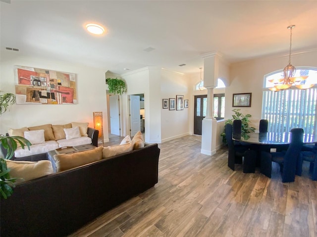 2041 Gold Dust Ct, Trinity, FL 34655 - living room featuring wood finished floors, a chandelier, ornamental molding, and baseboards