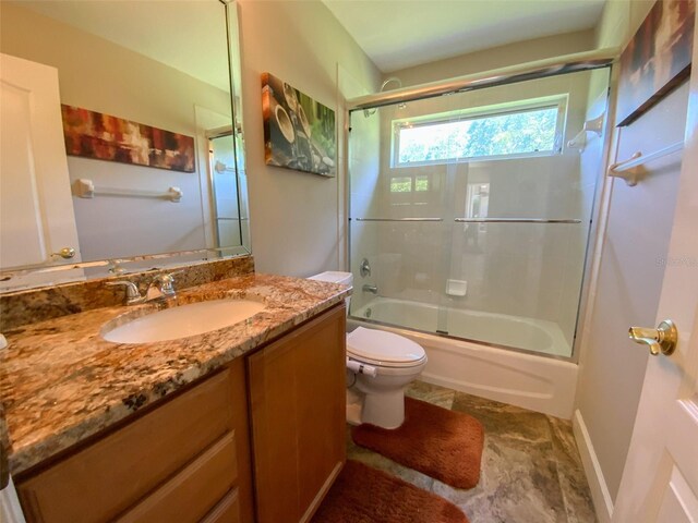 2041 Gold Dust Ct, Trinity, FL 34655 - full bath with toilet, vanity, and bath / shower combo with glass door