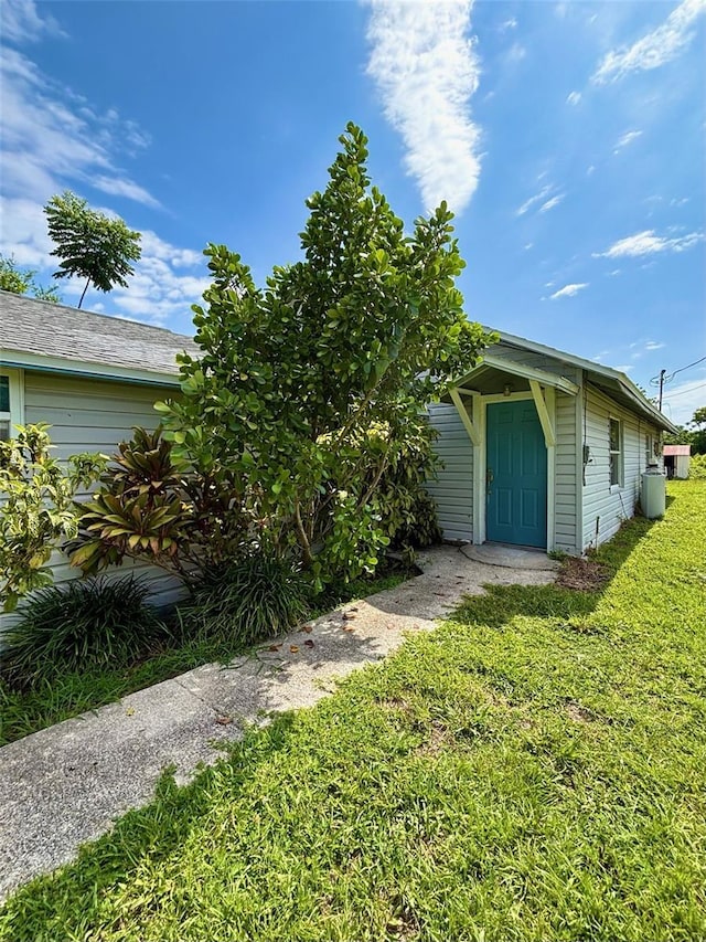 14318 Guava St, Hudson, FL 34667 - view of side of property featuring a lawn
