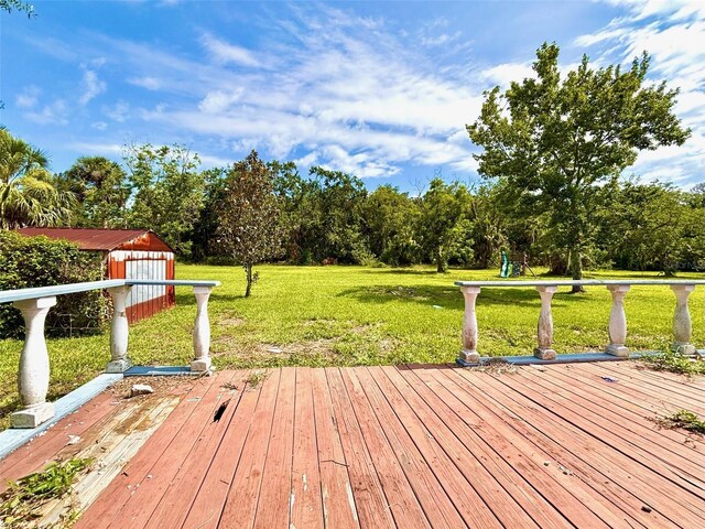 14318 Guava St, Hudson, FL 34667 - wooden deck with a yard and view of scattered trees