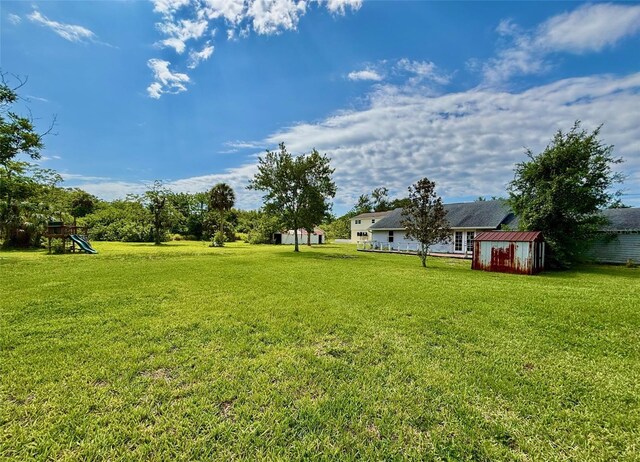 14318 Guava St, Hudson, FL 34667 - view of grassy yard with a playground