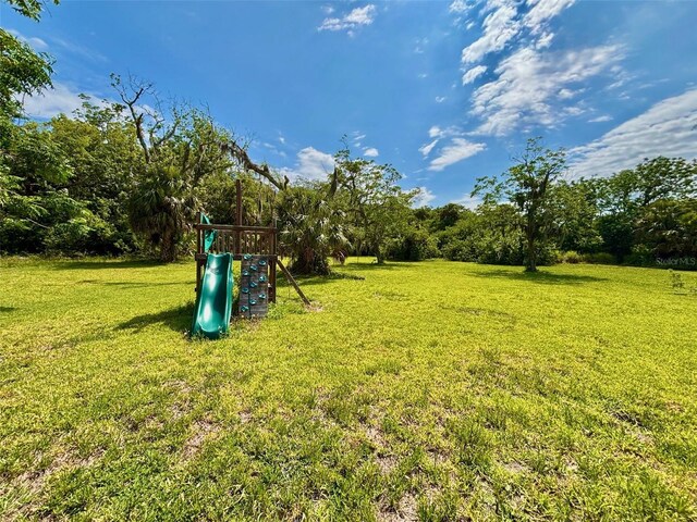 14318 Guava St, Hudson, FL 34667 - view of green lawn featuring a playground
