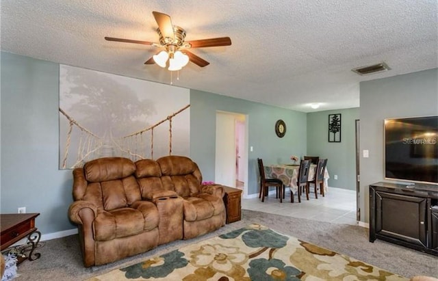 14318 Guava St, Hudson, FL 34667 - living area featuring a textured ceiling, a ceiling fan, carpet, and baseboards