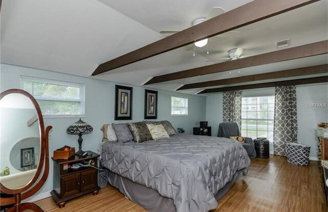 14318 Guava St, Hudson, FL 34667 - bedroom with light wood-style flooring, beam ceiling, and baseboards