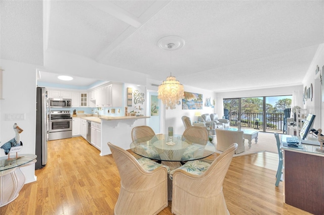 2700 Bayshore Blvd Unit 11308, Dunedin, FL 34698 - dining space with light wood-style flooring and a chandelier