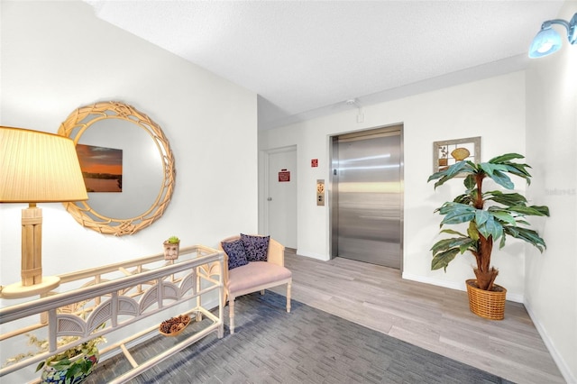 2700 Bayshore Blvd Unit 11308, Dunedin, FL 34698 - corridor with elevator, wood finished floors, and baseboards